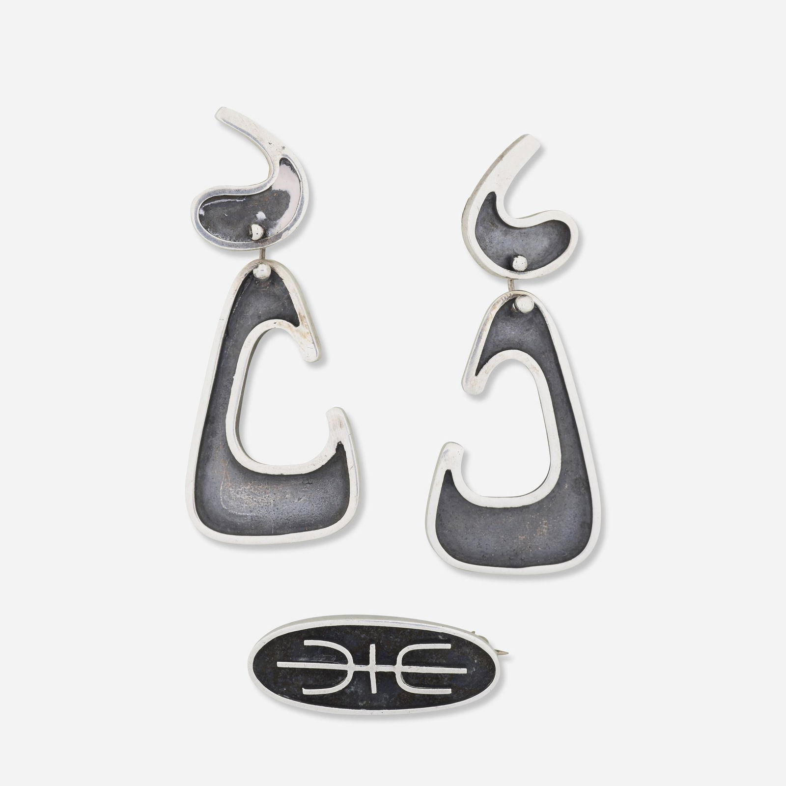Ed Wiener, Silver earrings and brooch: Ed Wiener Silver earrings and brooch Sterling silver Earrings: signed Ed Wiener, sterling; Brooch: signed, Wiener Earrings: 7/8 x 2 ins; Brooch: 1 1/8 x 1/2 ins; Gross weight: 13.8 dwts