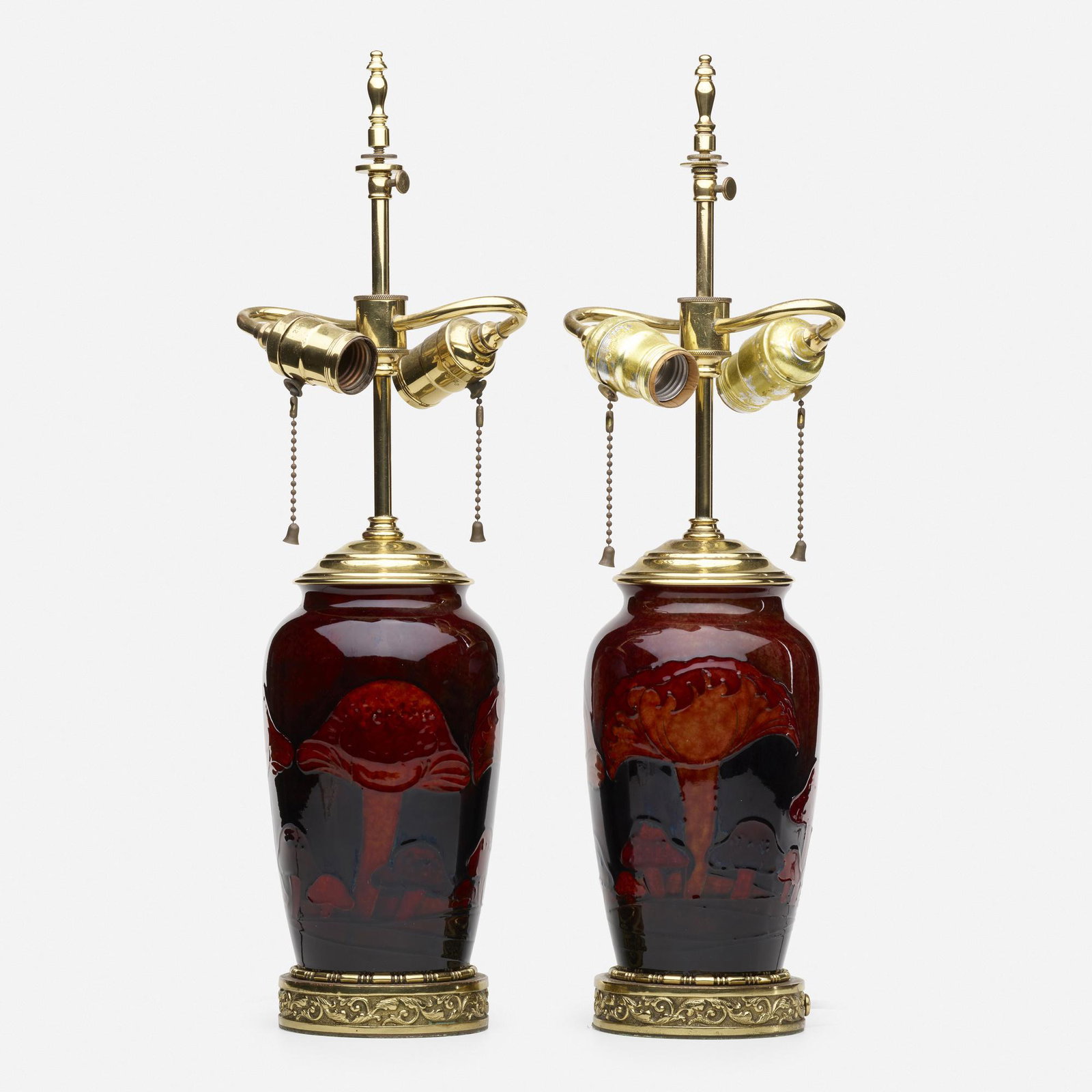 Moorcroft, Claremont lamps, pair: Moorcroft Claremont lamps, pair England Red Flambe glazed earthenware, brass 21 h inches, vases only: 8 h inches please note: This work is located at, and will ship from, Rago in Lambe