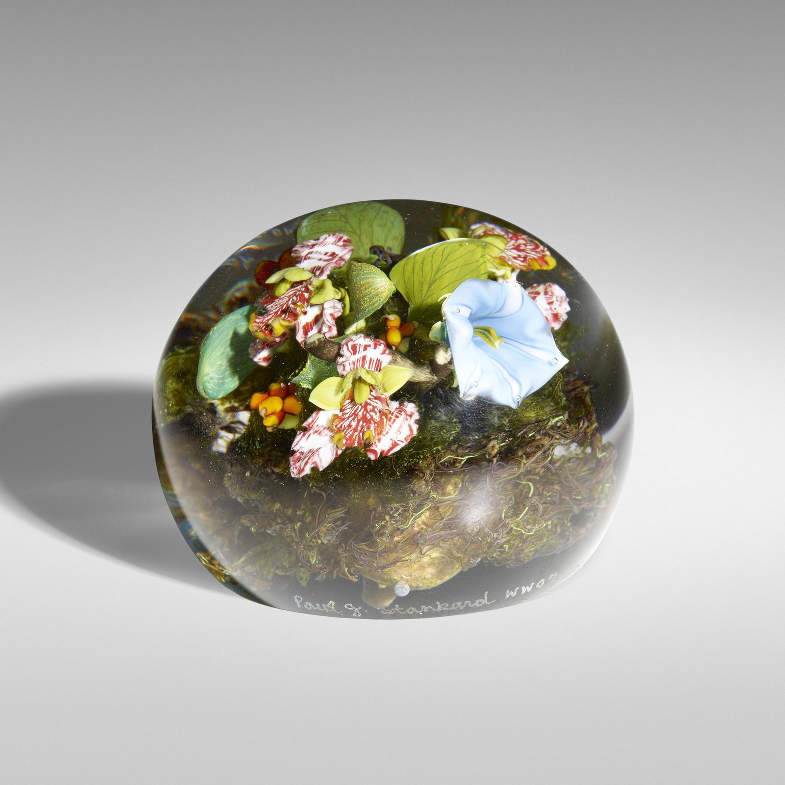 Paul Stankard, Botanical paperweight: Paul Stankard Botanical paperweight USA, 2002 lampworked glass, polished clear glass 2.25 h × 3 dia in (6 × 8 cm) Paperweight features morning glory, orchids, and face/mask. Etched sign