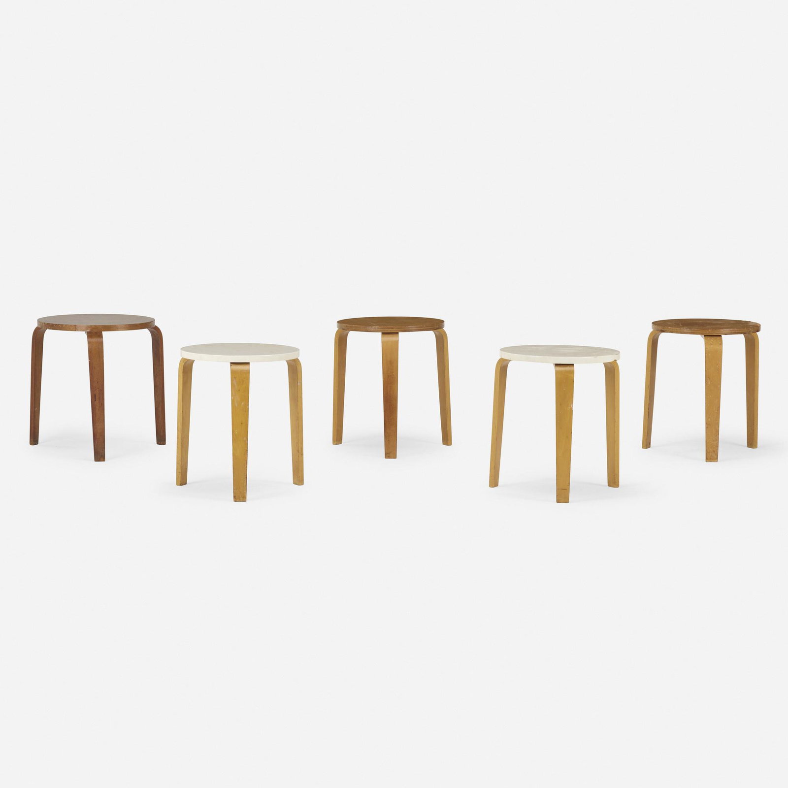 In the manner of Alvar Aalto, stools, set of five: In the manner of Alvar Aalto stools, set of five late 20th century laminated birch and teak, enamel, laminate Largest measures: 15.5 dia x 16.75 h inches.