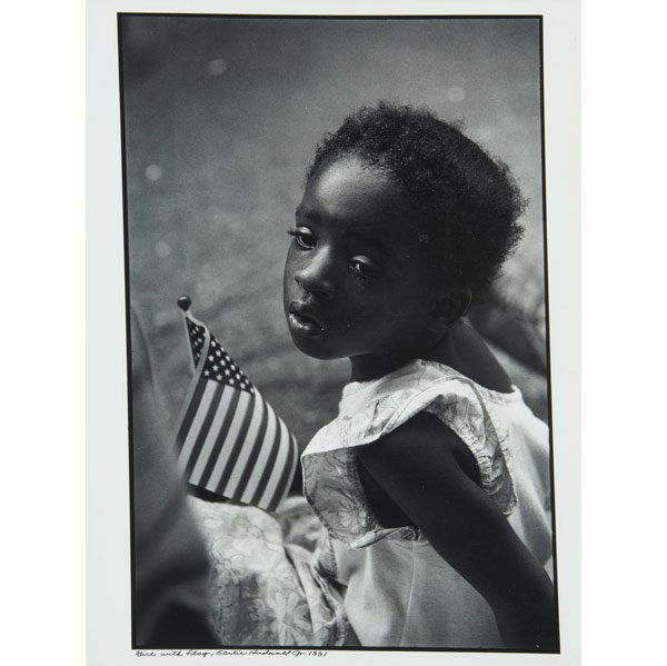 EARLIE HUDNALL, Jr. (American, b. 1946): EARLIE HUDNALL, Jr. (American, b. 1946) ''Girl With Flag,'' gelatin silver print, 1991. (Provenance: Estate of Joshua P. Smith, New York; Private Collection, New Jersey.) Signed, dated and titled. 20'