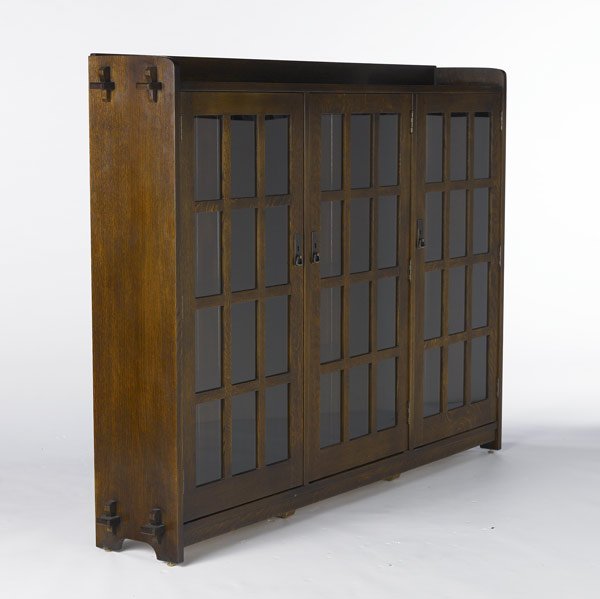 STICKLEY / E.J. AUDI: STICKLEY / E.J. AUDI Reproduction three-door bookcase with gallery top, D-pulls and three bays, each with one fixed shelf and two adjustable shelves. 55'' x 76'' x 12''