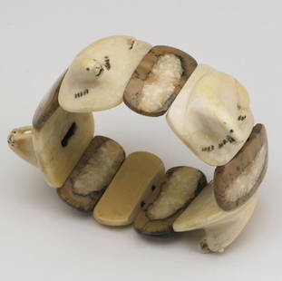 INUIT IVORY BRACELET, ALASKA: INUIT IVORY BRACELET, ALASKA Made of carved medallions depicting two polar bears, a seal, and a walrus, joined by contrasting bone tablets, on elastic, 1940s. (Provenance: Benedict Tatti collection,