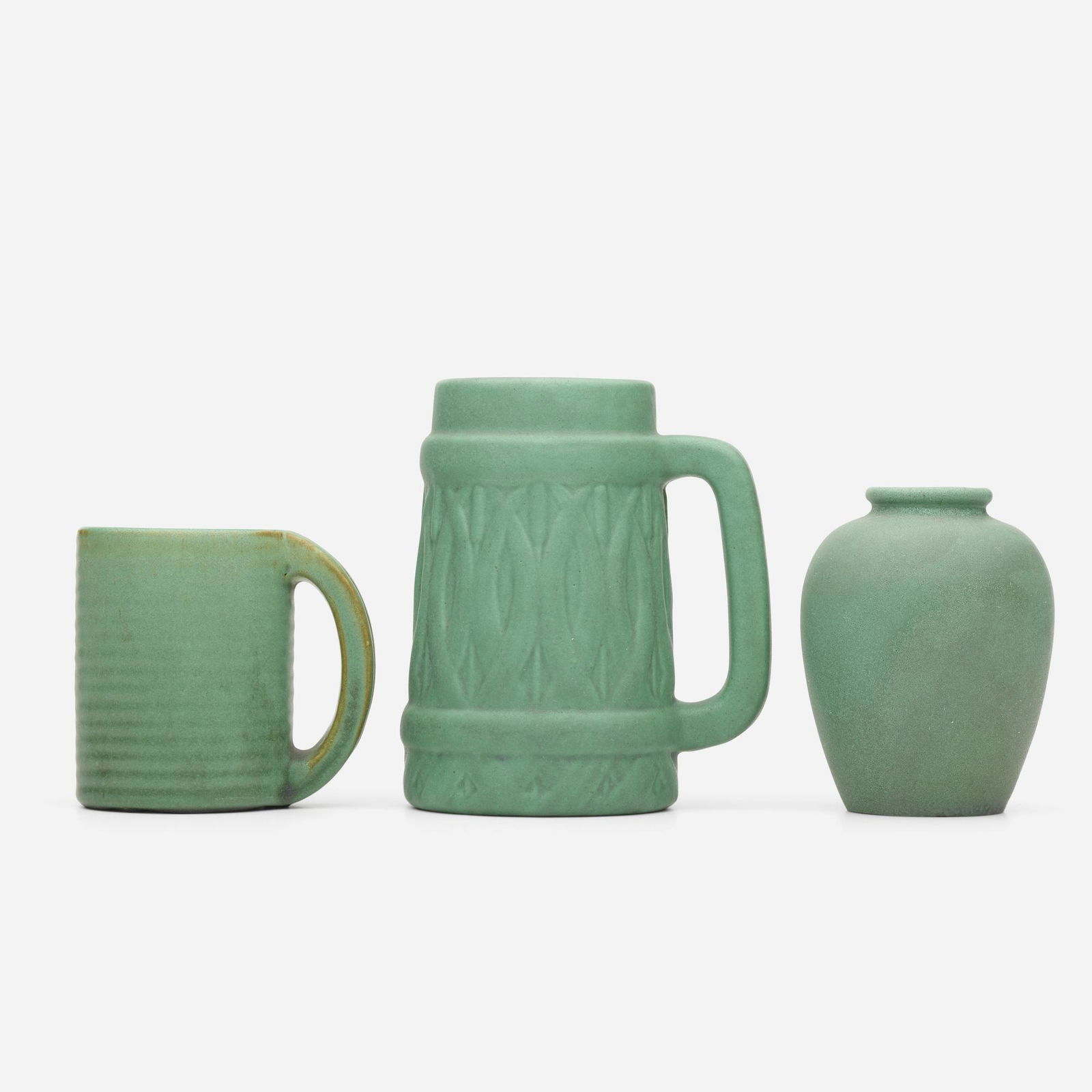 Teco Pottery, collection of three works: Teco Pottery collection of three works USA, 1902-20glazed earthenware5.75 h × 4.75 w × 3.75 d in (15 × 12 × 10 cm) Lot is comprised of two mugs and one vase; vase measures