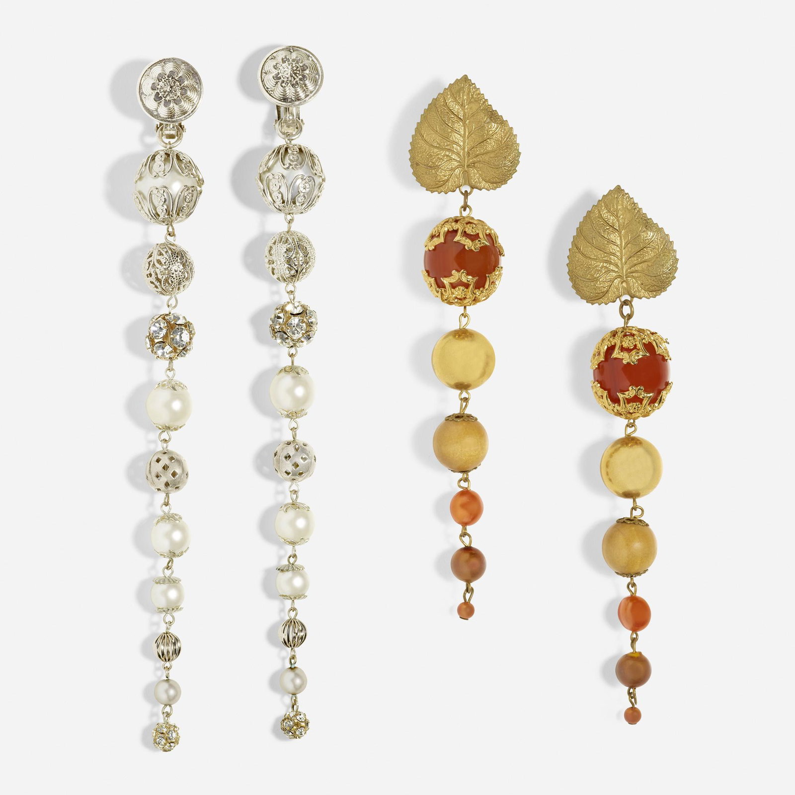 Sam & Joe Tassel, Two pairs of long earrings: Sam & Joe Tassel Two pairs of long earrings One a leaf suspending warm toned beads, the other of faux pearls, rhinestones, and silver toned beads Base metal Sold to Benefit the Dina Wind Art Found
