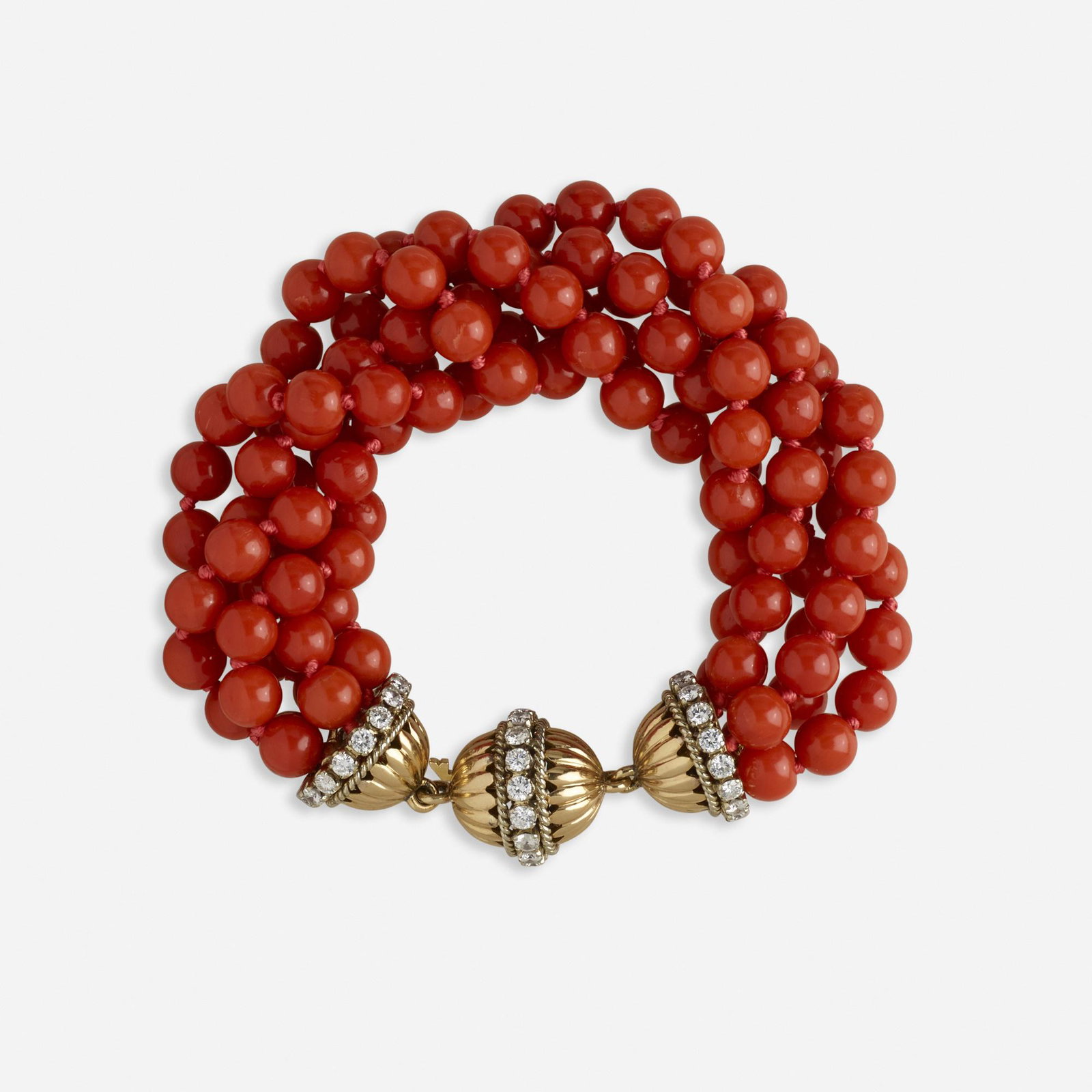 Five strand coral and diamond bracelet: Five strand coral and diamond bracelet Of coral beads, joined by a gold and round brilliant-cut diamond clasp Yellow gold 8 1/2 ins; Gross weight 48.4 dwts