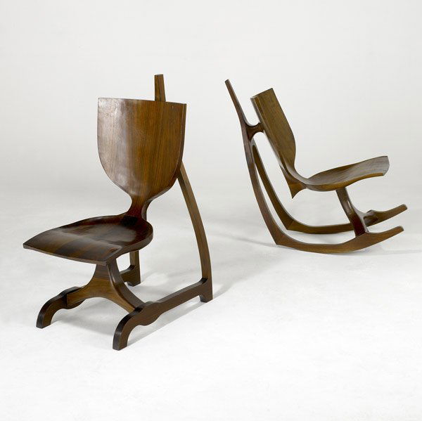 JACK ROGERS HOPKINS Pair of Chairs: JACK ROGERS HOPKINS (Reproduction) Pair of sculpted walnut chairs, one on rocking base. 37 1/4'' x 17'' x 25 1/2''; rocker: 32'' x 16 1/2'' x 36''