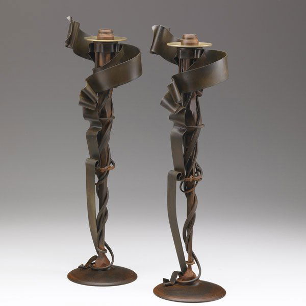 ALBERT PALEY Candlesticks: ALBERT PALEY Pair of tall forged and fabricated steel Millenium candlesticks, each with a brass bobeche. Signed ALBERT PALEY 2002. 21 1/4'' x 7'' x 5 3/4''