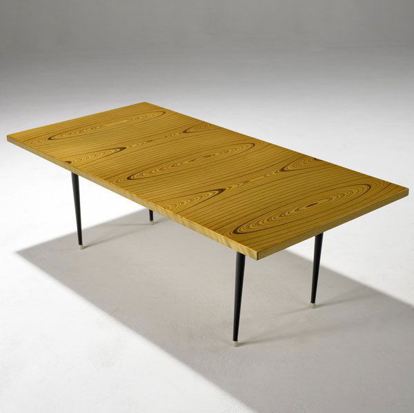 TAPIO WIRKKALA / ASKO OY Coffee table: TAPIO WIRKKALA / ASKO OY Coffee table with woodgrain pattern in birch and teak laminate top on black enameled metal legs. 17'' x 49'' x 29 1/2''