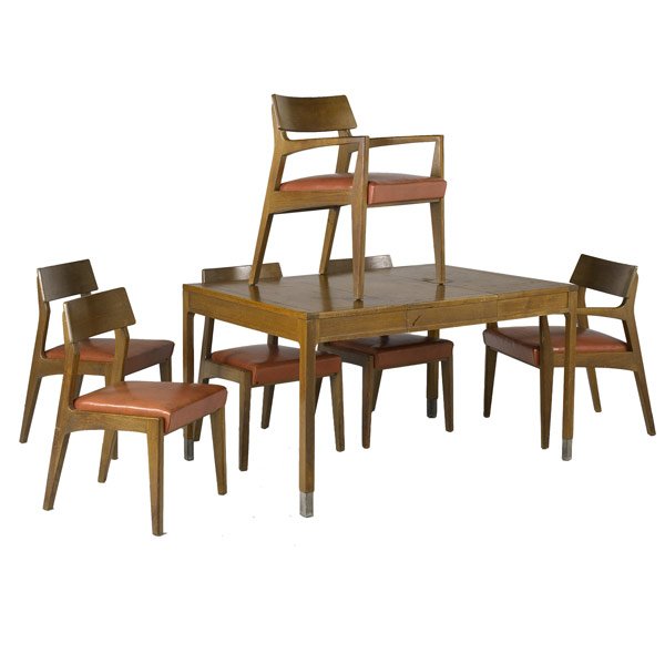 JOHN STUART: JOHN STUART Walnut extension dining table with steel-capped feet and two 18'' leaves, along with set of six sculptural chairs with leatherette cushions. John Stuart tags and circular labels to chairs.