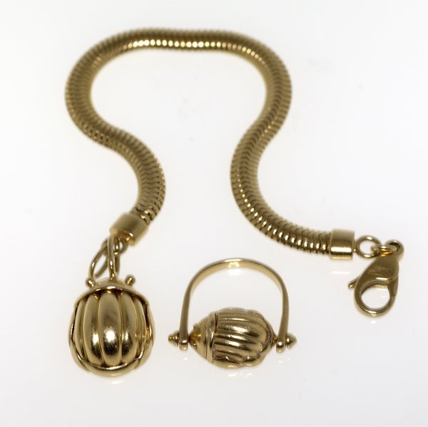 TIFFANY & CO. Gold scarab bracelet and ring: TIFFANY & CO. Gold scarab bracelet and ring, 18k yg. Gaspipe bracelet suspends scarab, 1993; ring scarab pivots. 35.6 gs. GW. 7 1/4'' bracelet. Ring size 7.
