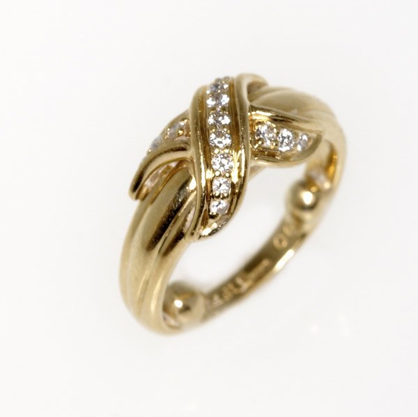 TIFFANY & CO. Signature 18k yg and diamond ring: TIFFANY & CO. Signature 18k yg and diamond ring. 6.7 gs. GW. Size 6 (sizing beads in interior)