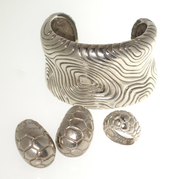 TIFFANY & CO. Three pieces of silver jewelry: TIFFANY & CO. Three pieces of silver jewelry: 1 3/4'' cuff; ring, size 6; 1 1/4'' earrings. 120 gs. GW