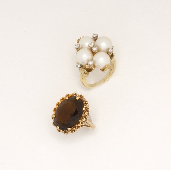 GOLD AND GEMSTONE RINGS : GOLD AND GEMSTONE RINGS Ca. 1960. Akoya pearl quatrefoil and diamond ring, 18k yg, pearls: 8.5mm-8.75mm, diamonds: .30 ct. TW size 6 together with a smoky topaz, 14k yg, 19.9 gs. GW, size 6 1/2.