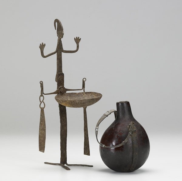 AFRICAN OIL LAMP AND GOURD VESSEL : AFRICAN OIL LAMP AND GOURD VESSEL Hand-hammered iron figural oil lamp from the Dogon of Mali together with an old gourd vessel from Central Africa, both early to mid 20th C. Tallest: 11 1/4''