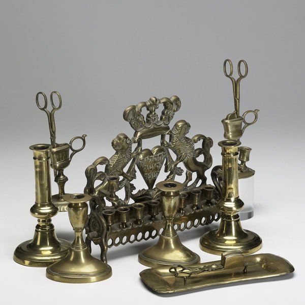 BRASS CANDLEHOLDERS & ACCESSORIES Nine pieces: BRASS CANDLEHOLDERS & ACCESSORIES Nine pieces include two pairs of candlesticks, candle snuffer with tray, two candle snuffers in holders and English Menorah. Largest: 10'' x 9 1/2'' x 3''