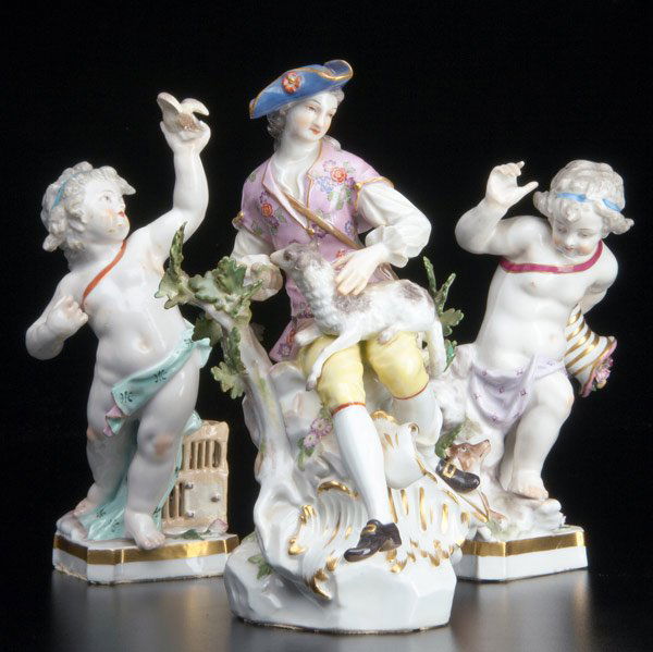 CONTINENTAL PORCELAIN Group of figurines: CONTINENTAL PORCELAIN Group of figurines: young man and lamb by a tree, 19th C., losses, early Meissen mark (crossed sword and dot); pair of putti, one holding a bird, several restorations, other with