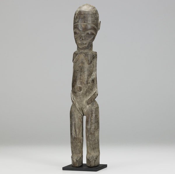 LOBI FEMALE SPIRIT FIGURE : LOBI FEMALE SPIRIT FIGURE Burkina Faso, Africa. Carved wooden shrine figure known as a Bateba Phuwe or Thil, in classic form with encrusted surface suggesting ritual use. On custom display stand. 15"