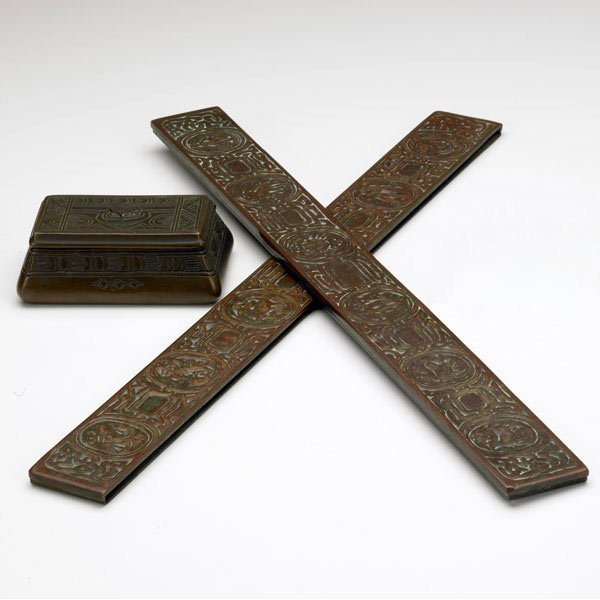 TIFFANY ZODIAC Desk set: TIFFANY STUDIOS Three bronze desk set pieces: Zodiac blotter ends and Indian stamp box. Stamped TIFFANY STUDIOS NEW YORK. Box: 1 3/4'' x 4 1/2''