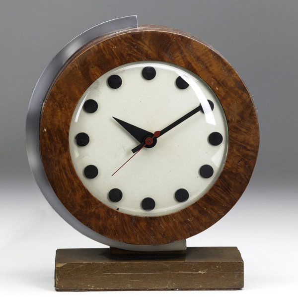 GILBERT ROHDE / HERMAN MILLER World's Fair clock: GILBERT ROHDE / HERMAN MILLER World's Fair desk clock in burlwood and chrome with black numeral markers. Herman Miller metal tag and numbered 4084B. 9'' x 7 1/2'' x 3''