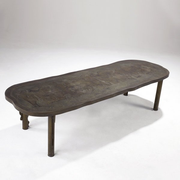 PHILIP & KELVIN LAVERNE Bronze-clad coffee table: PHILIP & KELVIN LAVERNE Freeform bronze-clad coffee table depicting Grecian figures on a raised and etched surface, with buttressed columnar legs. Signed Philip & Kelvin Laverne. 17'' x 69'' x 23''