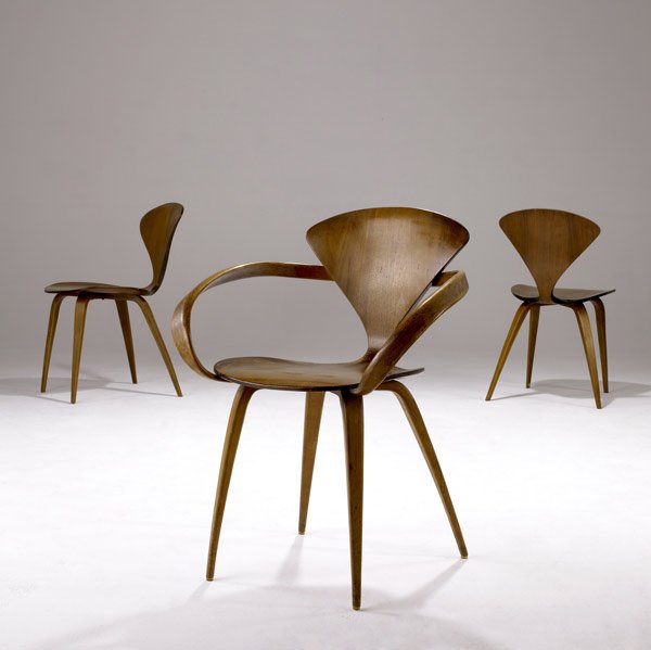 NORMAN CHERNER / PLYCRAFT Three Pretzel chairs: NORMAN CHERNER / PLYCRAFT Three Pretzel chairs in walnut plywood, one with arms. Armchair: 31 1/4'' x 24'' x 20 1/2''; sidechair: 31 1/2'' x 19 1/2'' x 19''