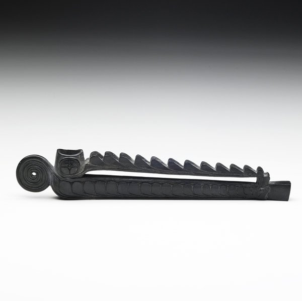 Haida argillite pipe: Haida argillite pipe, Pacific Northwest Coast. Carved trade pipe with detailed geometric designs resembling ocean waves with a spiral finial. Intact with no repairs, minor nick to pipe bowl, otherwise