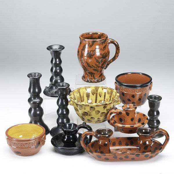 Eleven James Seagraves redware pieces: Eleven James Seagraves redware pieces, 20th C. Three chambersticks, three bowls, vase and four single black candlesticks. Marked JCS. Tallest: 8''