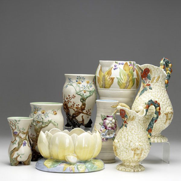 Eight pieces of Clarice Cliff: Eight pieces of Clarice Cliff, English, 20th C. Four pitchers and four vases with floral decoration. Tallest: 11''