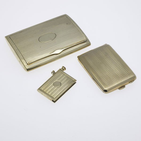 THREE GOLD ACCESSORIES 1900-1930: THREE GOLD ACCESSORIES 1900-1930. 14k yg card case; 9k vesta case; 14k mechanical match. 121 gs. GW. Largest: 3 3/8'' x 2 1/2''