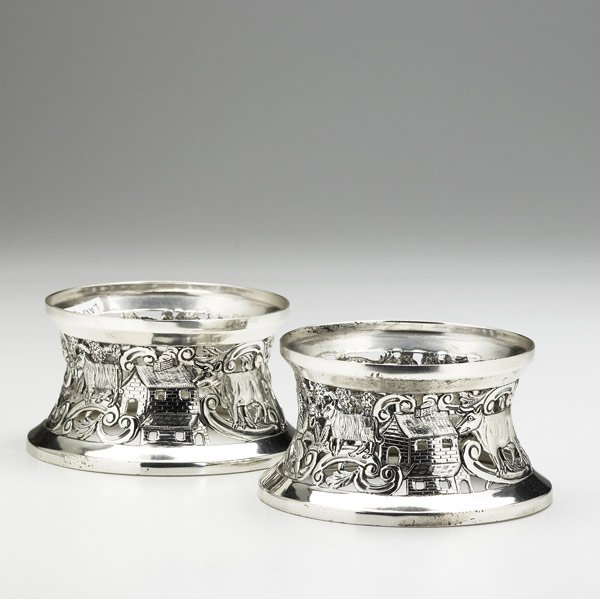 WAKELY & WHEELER PIERCED IRISH SILVER DISH RINGS: WAKELY & WHEELER PAIR OF PIERCED IRISH SILVER DISH RINGS Dublin, 1924. Raised and chased scenic bands with musicians, farmers, livestock and houses. 8 OT. 2 1/2'' x 4 1/2''