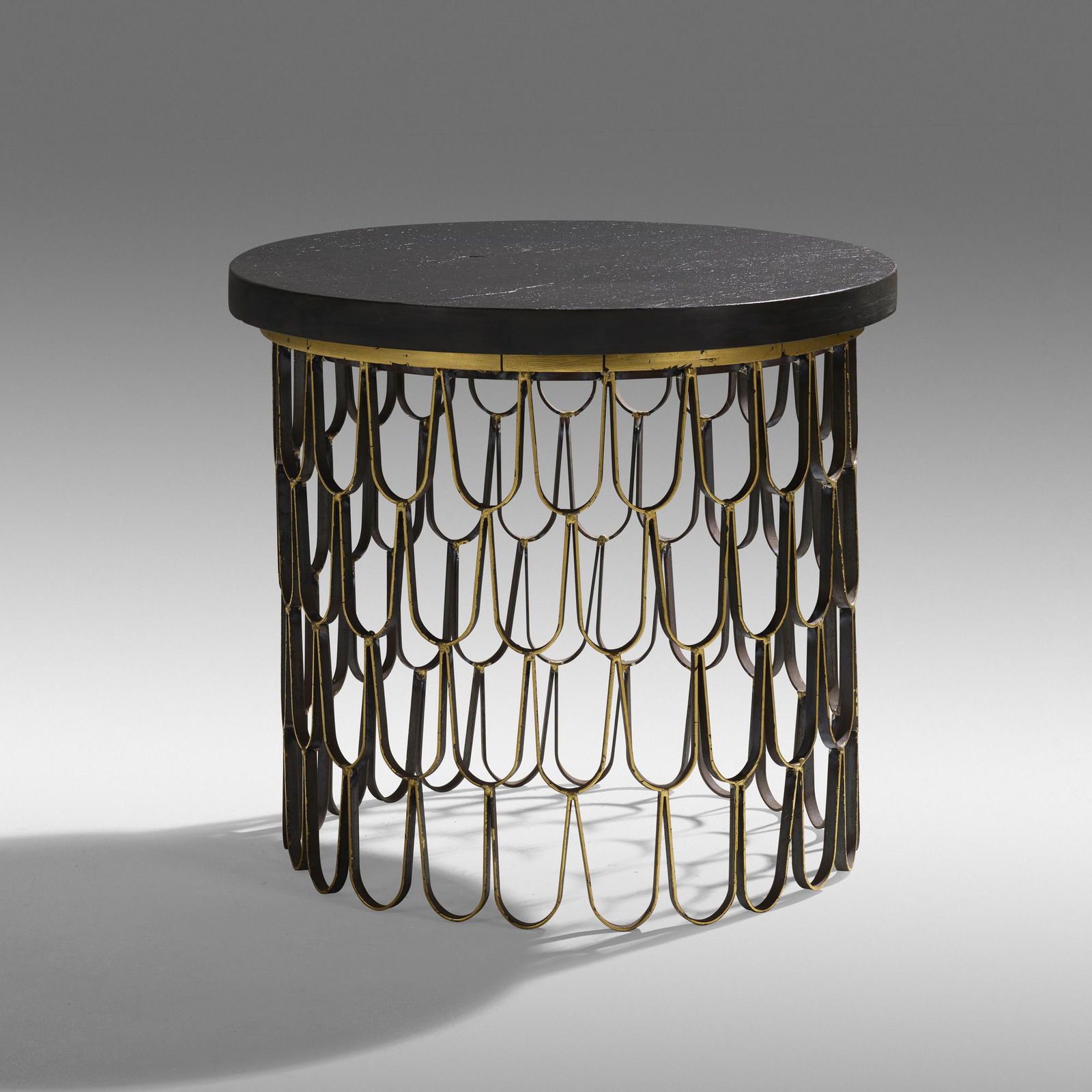 Paul Evans, Loop occasional table: Paul Evans Loop occasional table Paul Evans StudioUSA, c. 1965patinated iron, 23 karat gold leaf, wood, cleft slate22.25 h × 24 dia in (57 × 61 cm) Provenance: