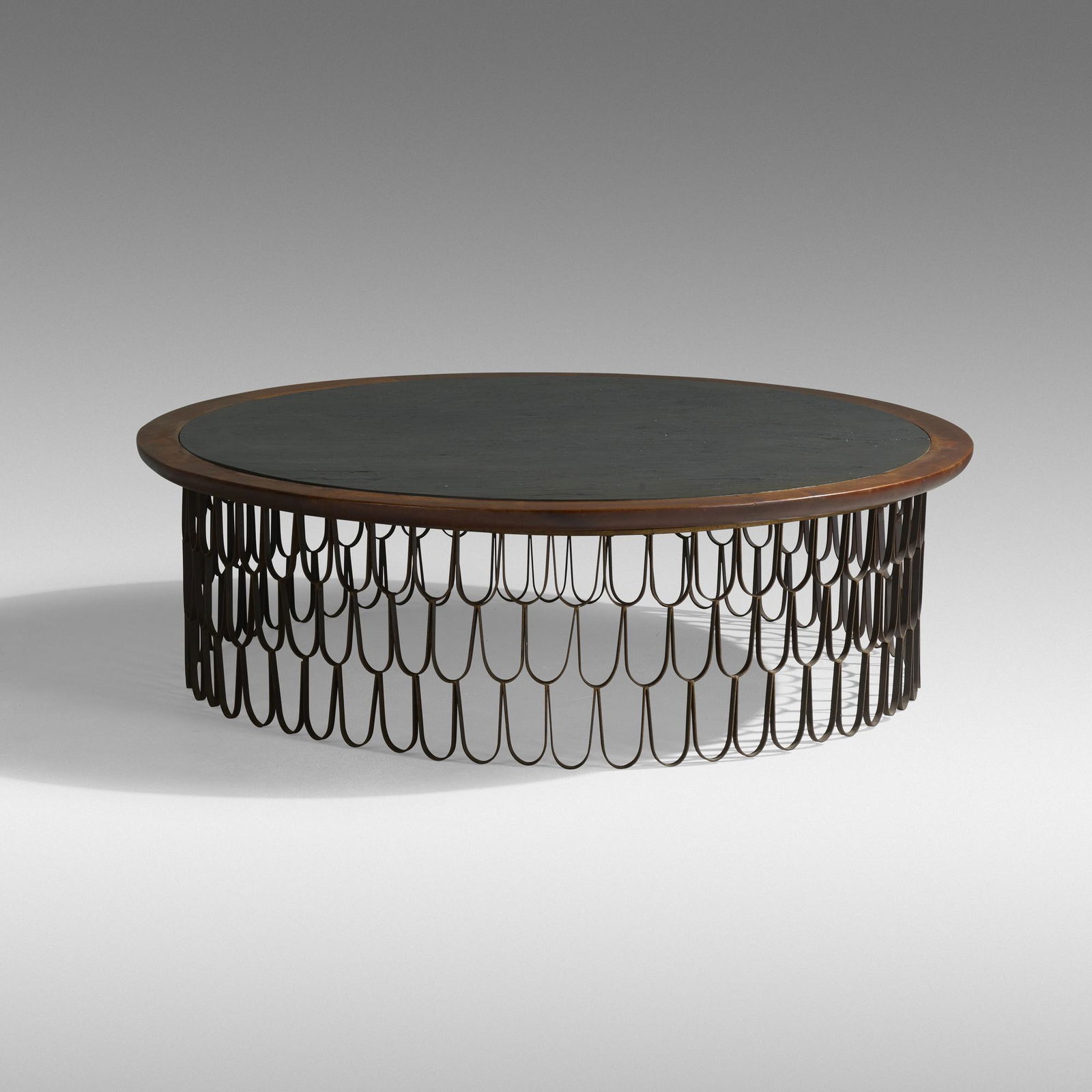 Paul Evans and Phillip Lloyd Powell, Large coffee table: Paul Evans and Phillip Lloyd Powell Large Loop coffee table USA, c. 1960enameled iron, walnut, 23 karat gold leaf, slate18.25 h × 60 dia in (46 × 152 cm) Provenance: Acquired dir