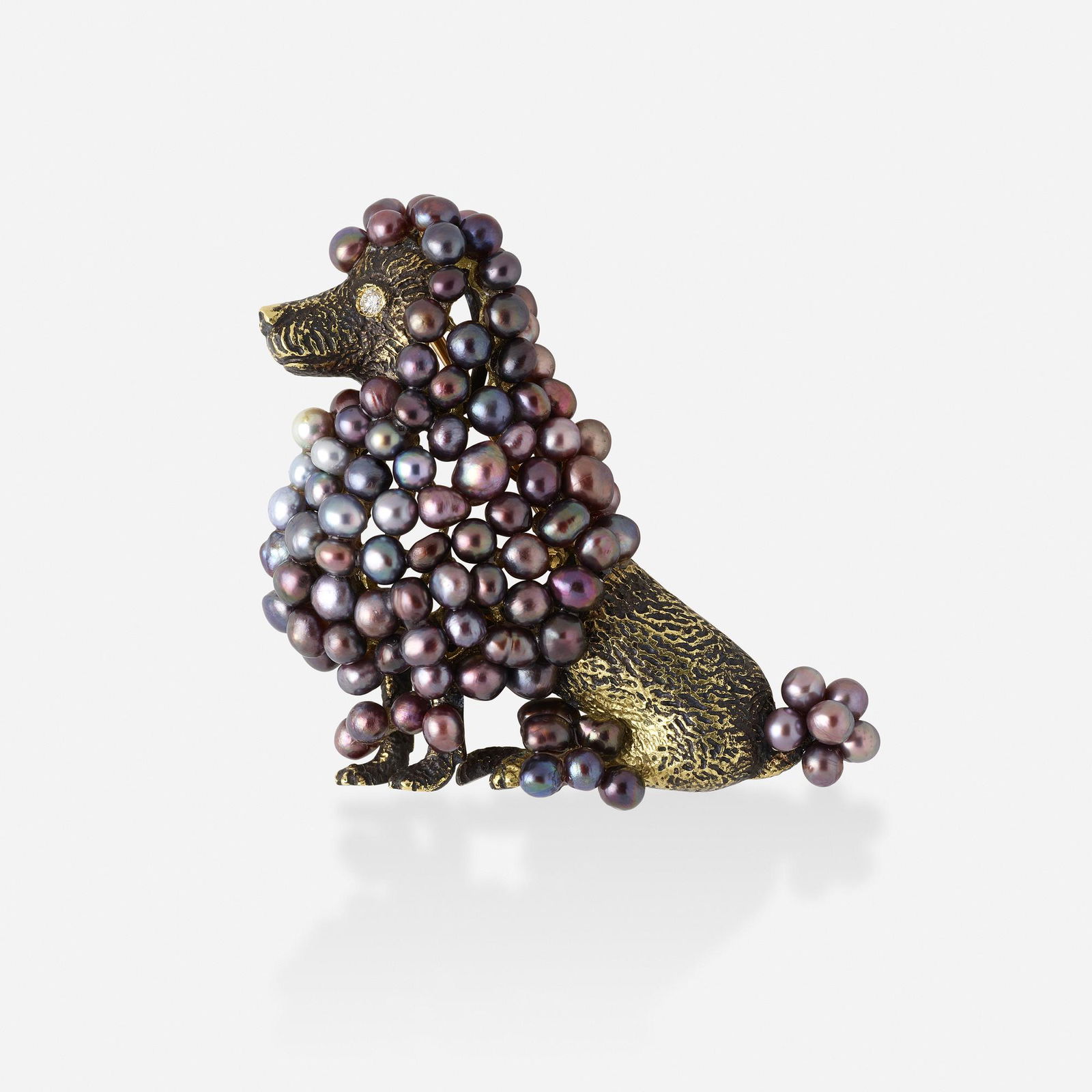 Julius Cohen, Seed pearl and gold poodle brooch: Julius Cohen Seed pearl and gold poodle brooch With grey seed pearl hair and a round brilliant-cut diamond eye Yellow gold Signed Julius Cohen 1 ¾ x 1 ¾ ins; Gross weight 14.9 dwts