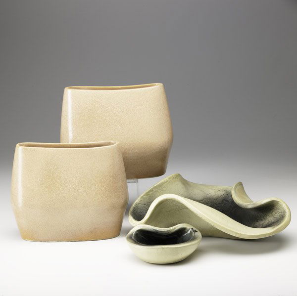 RUSSEL WRIGHT / BAUER Four vessels: RUSSEL WRIGHT BAUER Two matte green freeform bowls and a pair of apricot pillow vases All stamps visible, except on smallest bowl Bowl: 4 1/2'' x 13 1/2'', vases: 8 1/2'' x 10''