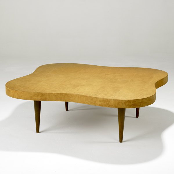 GILBERT ROHDE / HERMAN MILLER Coffee table: GILBERT ROHDE HERMAN MILLER Undulating coffee table in paldao veneer (no. 4188) Stenciled 4188 15'' x 44'' sq.