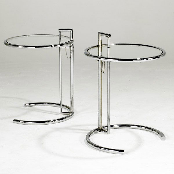 EILEEN GRAY PAIR OF OCCASIONAL TABLES: EILEEN GRAY Pair of adjustable occasional tables in chromed steel with plate glass tops. 27 1/2'' x 20'' dia.