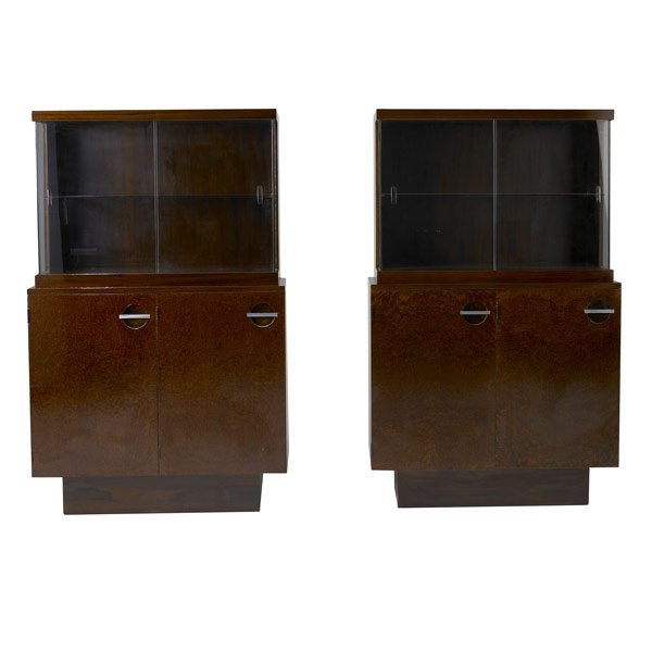GILBERT ROHDE / HERMAN MILLER PAIR OF ETAGERES: GILBERT ROHDE / HERMAN MILLER Pair of mahogany, burled walnut and rosewood etageres with steel pulls and interior adjustable shelves, each with glass doors and single shelf. 58'' x 36'' x 16 1/2''