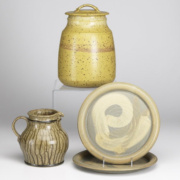 VAL CUSHING STONEWARE: VAL CUSHING Four stoneware pieces: covered jar, pitcher and two chargers. Each signed. Jar: 12'' x 8'' x 8''