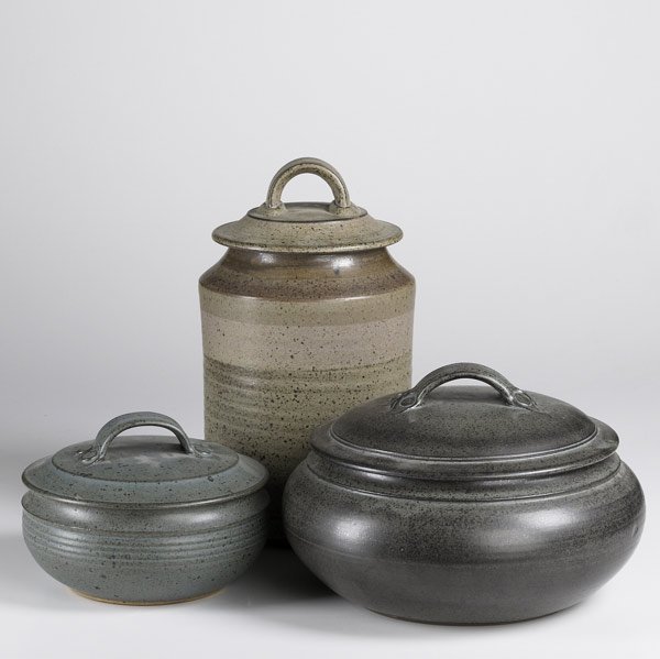 VAL CUSHING STONEWARE: VAL CUSHING Three stoneware pieces: covered jar and two covered bowls, all with stap handles. Jar dated 1986. Each signed. Covered jar: 14'' x 7'' x 7''; larger covered bowl: 8'' x 13'' x 13''; covere