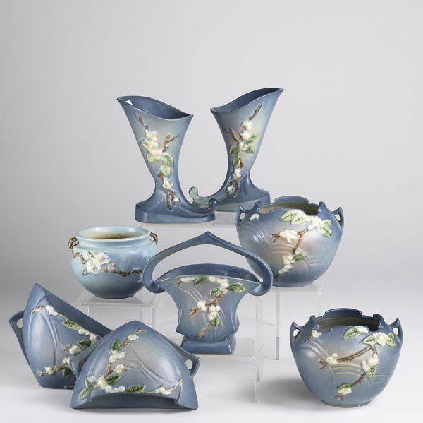 ROSEVILLE: ROSEVILLE Eight pieces of Blue Snowberry: two 8'' wall pockets, two 5'' planters, 7'' basket and two 8'' cornucopias. Together with a Dogwood 4'' planter. Damage to both cornucopias, chip to basket.