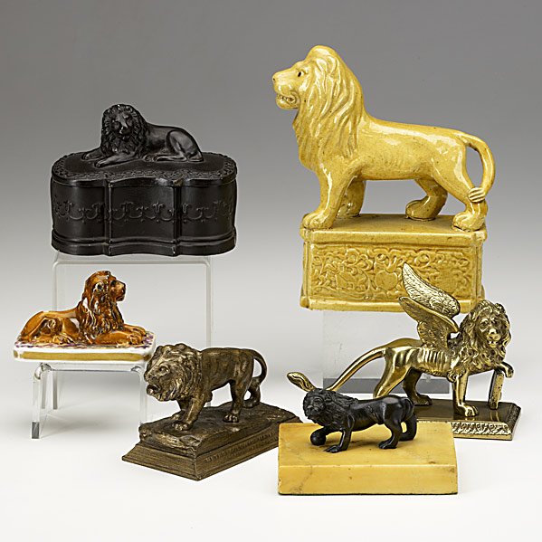 SIX LION FIGURES: SIX LION FIGURES; MGM paperweight, terra cotta box, yelloware figure, crossed swords reclining, patinated bronze on marble and brass winged lion, 19th/20th c.; Largest: 5'' x 6 3/4''