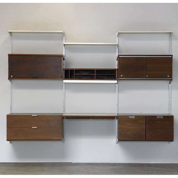 GEORGE NELSON; HERMAN MILLER Walnut CSS Unit: GEORGE NELSON; HERMAN MILLER; Walnut Comprehensive Storage Systems (CSS) with four vertical supports, five cabinets, one desktop and three enameled metal shelves; Herman Miller metal tag; 66'' x 96'' 