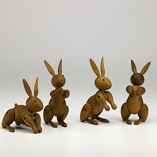 KAY BOJESEN Set of four padauk rabbit figurines: KAY BOJESEN; Set of four padauk rabbit figurines, 1957; Rare book, ''Applied Art by Kay Bojesen'' and two postcards; Each rabbit stamped COPYRIGHT 1957 KAY BOJESEN DENMARK; Rabbits: 5 3/4'' x 2 1/2'' 