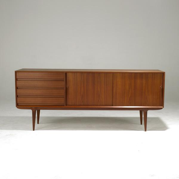OMANN JUN: OMANN JUN; Fine teak credenza with two sliding doors, four drawers and finished back; Model NR18; Metal label; 32 1/2'' x 79'' x 18 1/2''