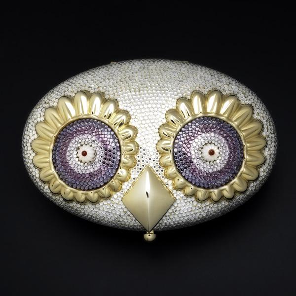 JUDITH LEIBER SILVER OWL MINAUDIERE: JUDITH LEIBER SILVER OWL MINAUDIERE; Oval form with large gilt metal and pink crystal eyes centered by carnelian accents on fluted mother of pearl; Gold leather interior, original purse, comb and mirr
