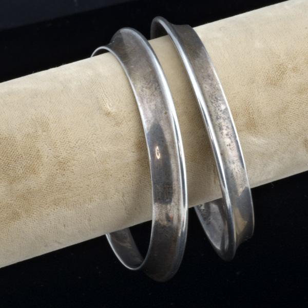 GEORG JENSEN: GEORG JENSEN; Two modernist silver bangles, #142A; Designed by Nanna Ditzel; 65 gs., 2 3/4''