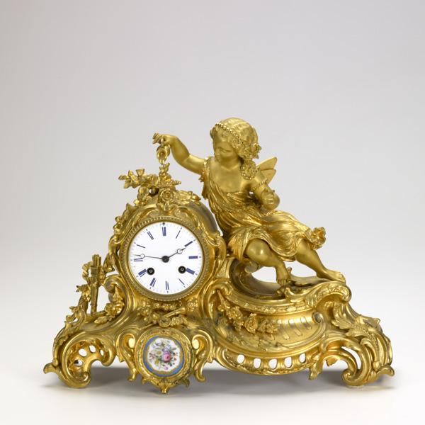FRENCH DORE BRONZE FIGURAL CLOCK: FRENCH DORE BRONZE FIGURAL CLOCK; Cherub pouring water, 19th c.; 12 1/4'' x 15'' x 5''