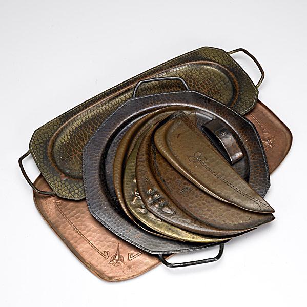 ROYCROFT: ROYCROFT; Eight metal items: three trays, pair of crumbers, crumber with knife and a single napkin ring; Loss of patina to most; Provenance: Roycroft Inn, East Aurora, NY; All with Orb & Cross mark; L