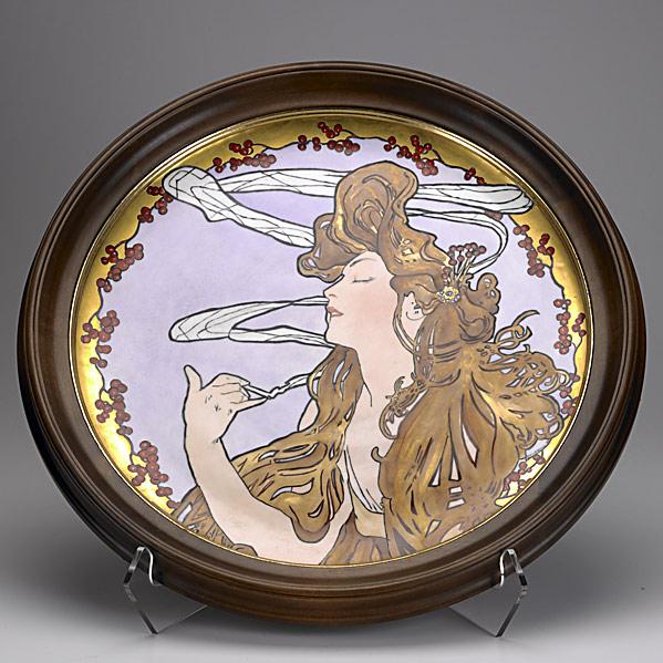 STYLE OF ALPHONSE MUCHA: STYLE OF ALPHONSE MUCHA; Large Art Nouveau charger painted with a smoking woman: Signed Florence Selmeir (?), dated 1907; 18'' dia.